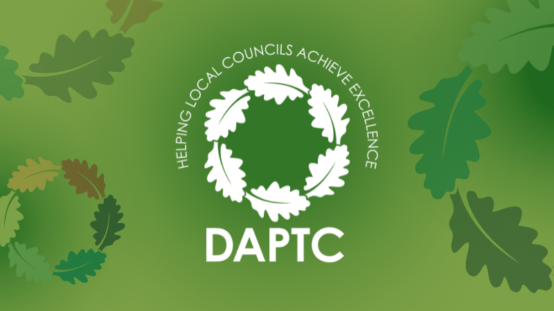 DAPTC logo in white against a light green background with different sized oak leaf circles around