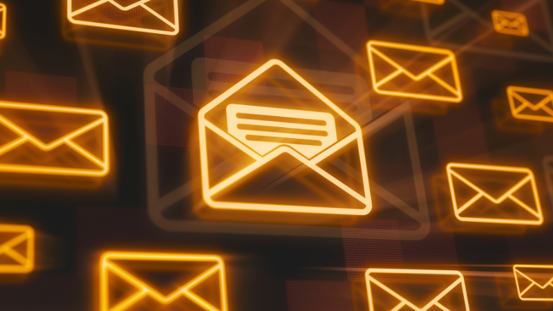 Email envelopes in shining orange against a dark background