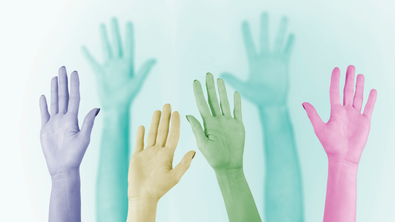 Hands held aloft, each tinted a different, unnatural colour